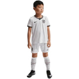 KODAA SPORT England 2026 World Cup kids' home kit: white jersey with black trim, white shorts, and white socks with red and black stripes.