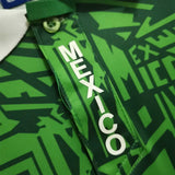 KODAA SPORT Mexico 1994 retro home football jersey with green geometric pattern and white 'MEXICO' text.