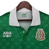 KODAA SPORT Mexico 1995 retro home football shirt. Green with white collar and repeating ABA SPORT logo pattern.