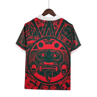KODAA SPORT Mexico 1997 retro football jersey with Aztec sun design in red and green, white collar and cuffs.