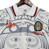 KODAA SPORT retro Mexico 1998 football jersey with Aztec-inspired print, white with grey and red accents.
