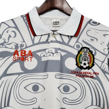 KODAA SPORT retro Mexico 1998 football jersey with Aztec-inspired print, white with grey and red accents.