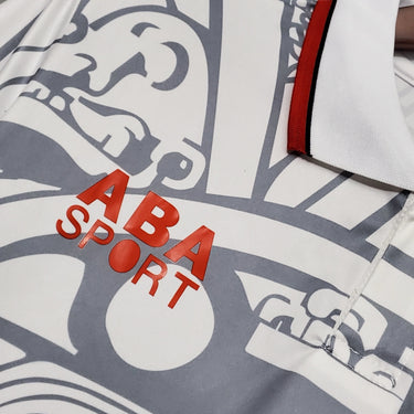 KODAA SPORT Mexico 1998 retro football jersey, white with grey Aztec-inspired pattern and red ABA SPORT logo.