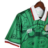 KODAA SPORT Mexico 1998 retro home football shirt, green with Aztec-inspired print, white collar with red trim.