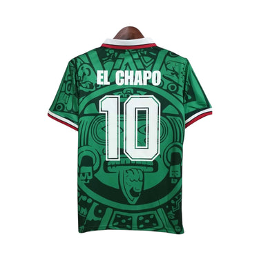 KODAA SPORTS Mexico 1998 retro home football jersey with 'EL CHAPO 10' on the back, featuring a green Aztec-inspired print and white collar with red trim.
