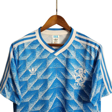 KODAA SPORTS retro Netherlands 1988 away football shirt with blue and white geometric pattern, white collar and sleeve stripes.