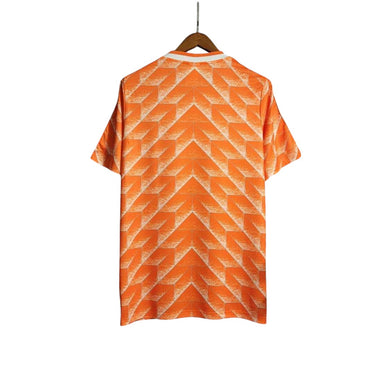KODAA SPORTS Netherlands 1988 retro home football shirt with orange and white geometric pattern. Short sleeves, white collar.