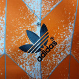 KODAA SPORTS Netherlands 1988 retro home football shirt with Adidas logo and abstract orange, white, and blue pattern.