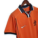 KODAA SPORTS Netherlands 1998 retro home football shirt. Orange short-sleeve jersey with black collar and white trim, featuring the Nike logo and KNVB crest.