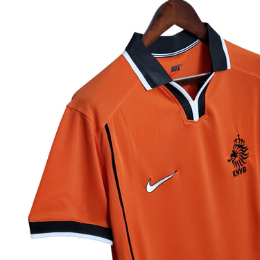 KODAA SPORTS Netherlands 1998 retro home football shirt. Orange short-sleeve jersey with black collar and white trim, featuring the Nike logo and KNVB crest.